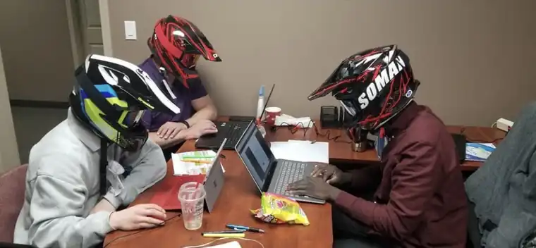 The team working in motocross helmets